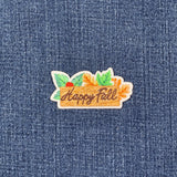 Embroidered patch with 'Happy Fall' text on a denim background