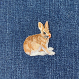 Embroidered rabbit or hare patch on denim fabric