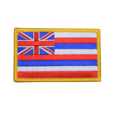 An embroidered patch depicting the flag of Hawaii with a red, white, and blue horizontal stripe pattern and a Union Jack in the corner, bordered in yellow.