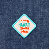 Embroidered patch with 'Hawaii Land Of Aloha' text on a denim background