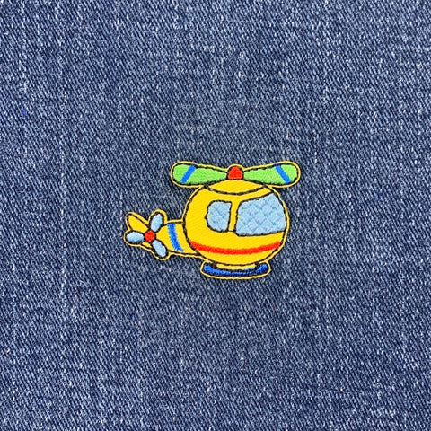 Colorful helicopter patch on denim fabric