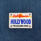 Embroidered patch with 'California Hollywood The Golden State' text on a denim background