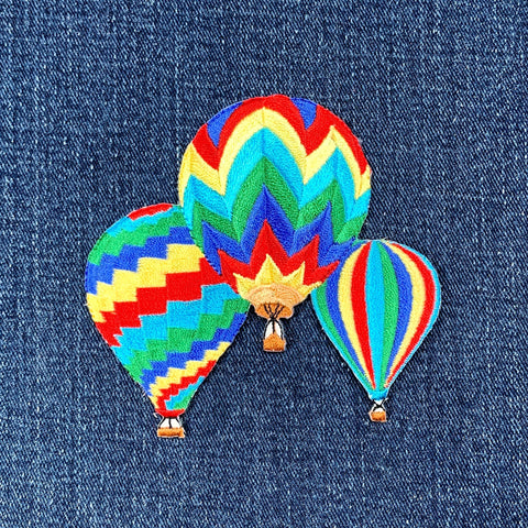 Colorful hot air balloon patch on denim fabric