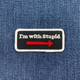 Patch with 'I'm with Stupid' text on a denim background