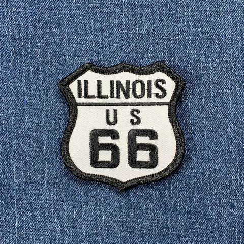 Illinois route 66 patch in the shape of a highway sign in black and white colors on a denim background.