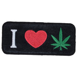 A black iron-on patch featuring the text 'I ❤️ LOVE CANNABIS' with a green cannabis leaf
