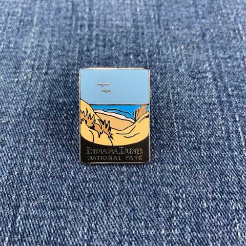 Pin with Indiana Dunes National Park design on a denim background