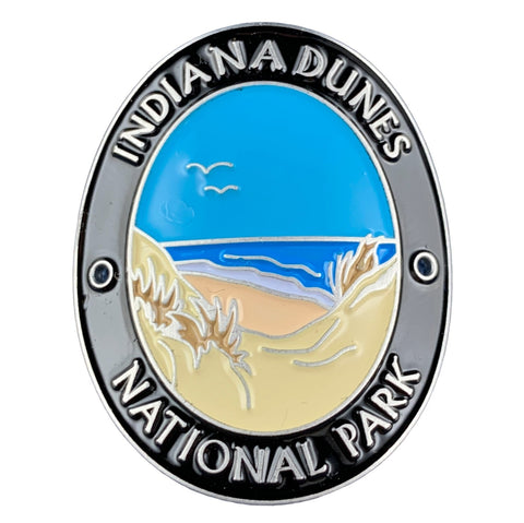 An oval walking stick medallion with an illustration of a beach and Lake Michigan, and the text 'Indiana Dunes National Park' 
