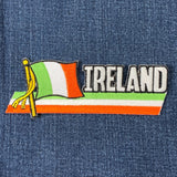 A patch featuring the flag of Ireland with a flagpole and the word 'IRELAND' at the bottom, on a denim background.