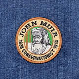 Patch with John Muir's face and text on a denim background
