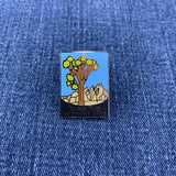 Pin with Joshua Tree National Park design on a blue denim background