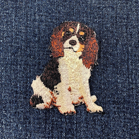 Embroidered king Charles cavalier dog patch on denim fabric