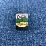 A pin featuring an illustration of a mountain range with the text 'Kobuk Valley National Park' at the bottom on a denim background