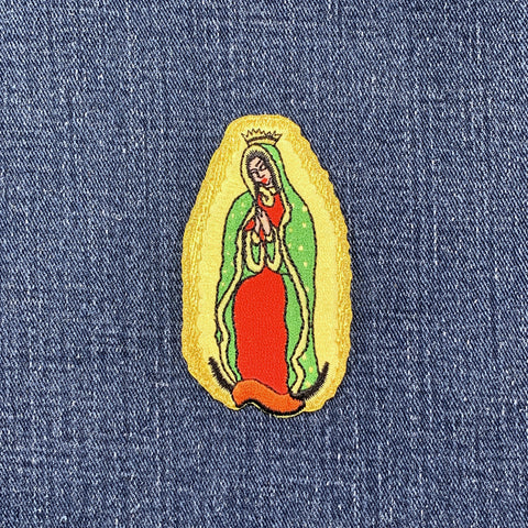 Embroidered patch of Our Lady of Guadalupe on denim fabric