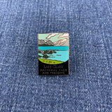 Pin with Lake Clark National Park design on a denim background