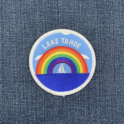 Patch with rainbow and 'Lake Tahoe' text on denim fabric
