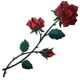 Detailed embroidered patch depicting a rose stem with two open red blossoms and one closed red bud. The flowers have a shimmering or iridescent quality, and the leaves and stems are dark green.