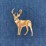 Embroidered deer patch on denim fabric