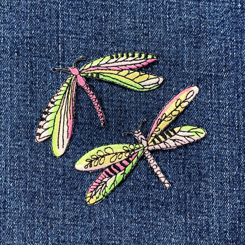 Colorful dragonfly patches on denim fabric