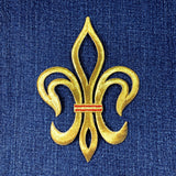 Gold fleur-de-lis symbol patch with a red stripe on blue denim