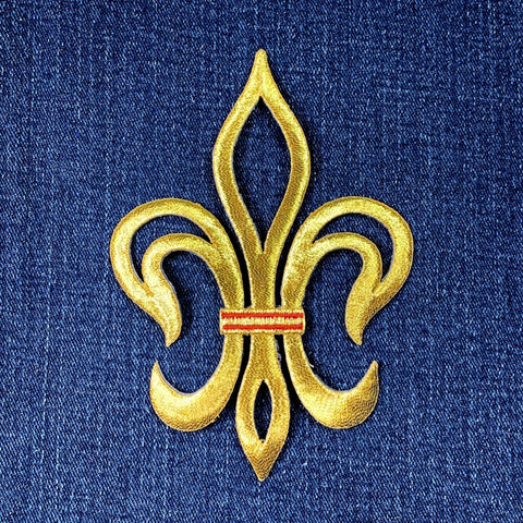 Gold fleur-de-lis symbol patch with a red stripe on blue denim