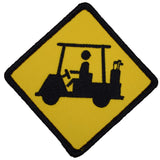 A patch with an image of a golf cart and a person driving it. The patch is yellow with a black outline and embroidery detail.