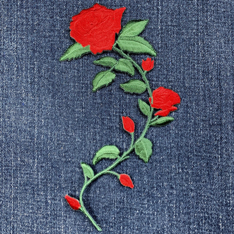 Embroidered red rose patch on denim fabric
