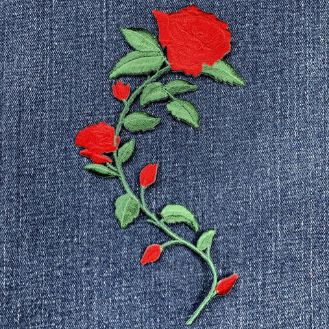 Embroidered red rose patch on denim fabric
