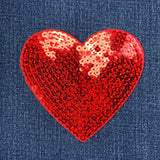 Sequined heart patch on denim fabric