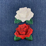 Embroidered red and white roses on denim fabric