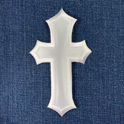 White cross-shaped patch on a blue denim background