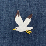Embroidered seagull patch on denim fabric