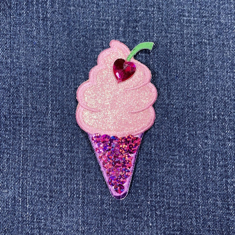 Pink sequin ice cream cone patch with a heart on denim fabric