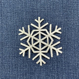 silver Decorative snowflake patch on a denim background