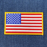 a large american flag patch on a denim background