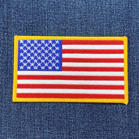 a large american flag patch on a denim background