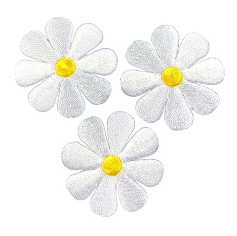 Three white embroidered daisy flowers with bright yellow centers, arranged on a plain white background.