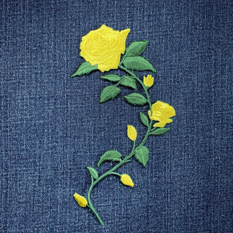 Embroidered yellow rose patch on denim fabric