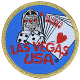 Embroidered circular blue patch with a golden border. Features a slot machine, dice, and a royal flush poker hand over the red text "LAS VEGAS USA"