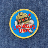 Embroidered patch of a robot with 'Las Vegas USA' text on denim fabric