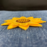 Yellow sunflower patch on a denim fabric background