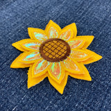 Sunflower-shaped patch on denim fabric