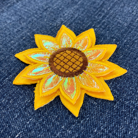 Sunflower-shaped patch on denim fabric