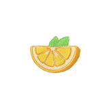 Embroidered patch of a lemon slice with green leaves on a white background
