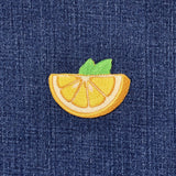 Embroidered lemon patch on denim fabric