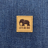 Denim fabric with a 'Let's Be Irie' patch featuring an elephant logo.