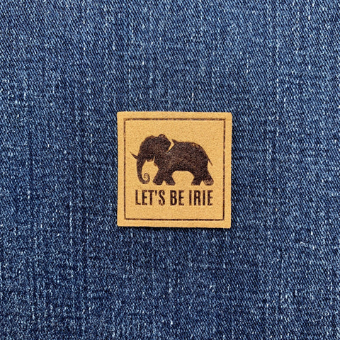 Denim fabric with a 'Let's Be Irie' patch featuring an elephant logo.