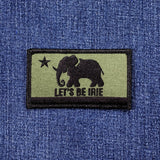 Patch with elephant design and 'Let's Be Irie' text on a blue denim background