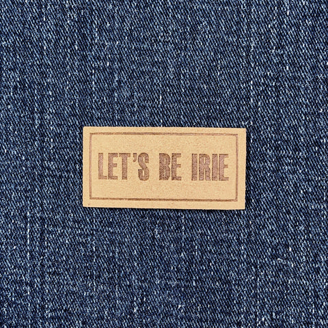 Microfiber patch with 'LET'S BE IRIE' text on a denim background