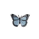 Butterfly-shaped patch with blue and black design on a white background